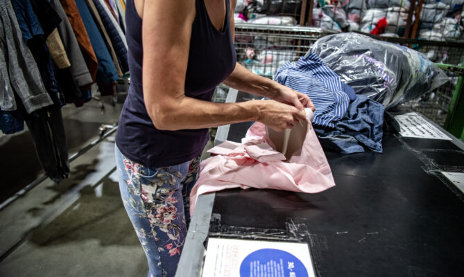 Zaměstnanci Second Hand Landu textil třídí podle kategorií. Foto: Kateřina Hefler, Ekonews